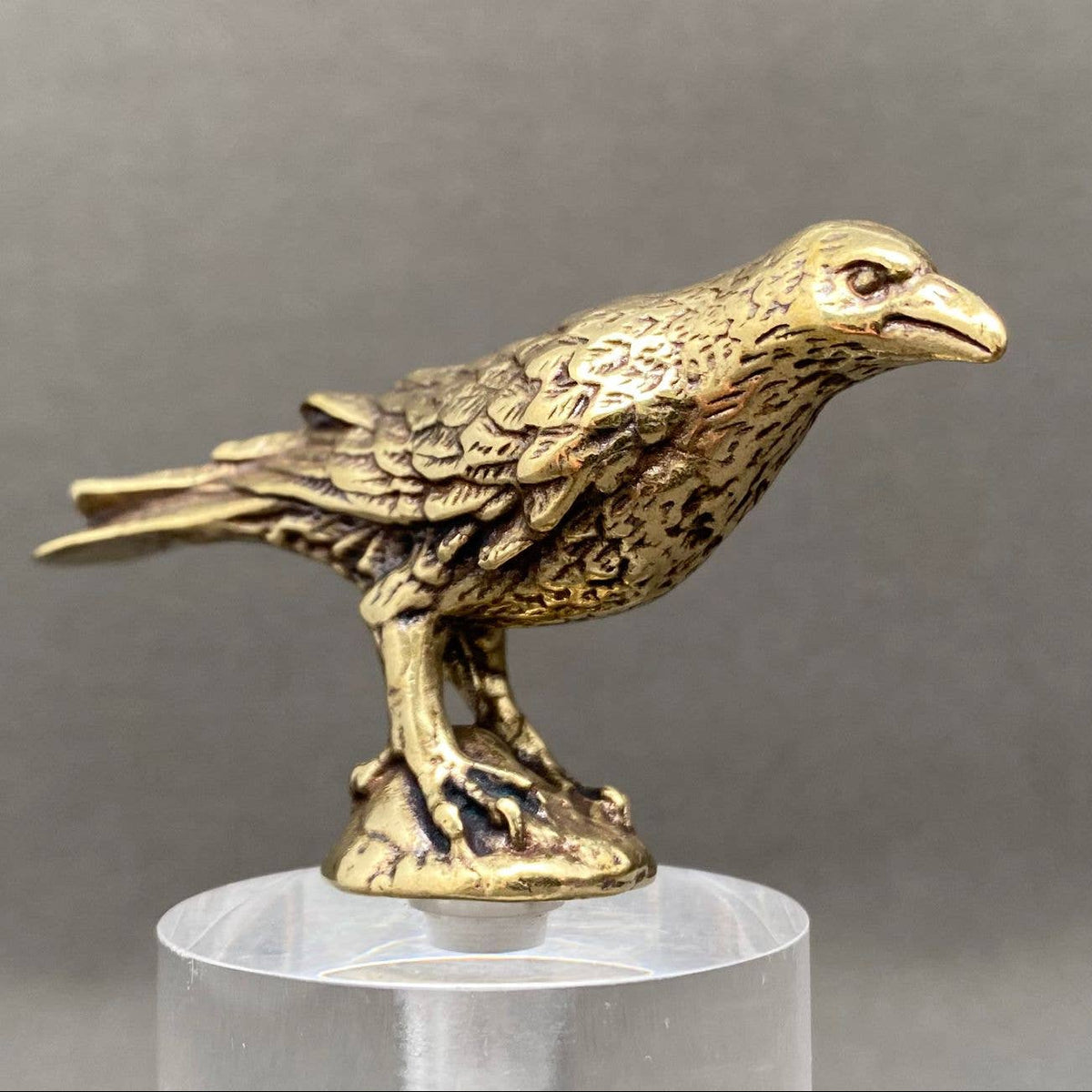 Tiny brass crow